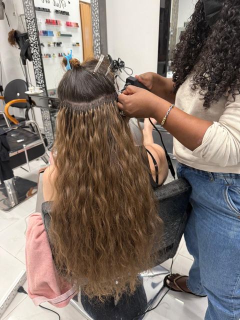 Our stylist securing hair extensions close to the root